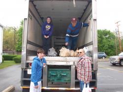 Volunteers unload donations from a KANE trailer during last year's "Stamp Out Hunger" food drive.